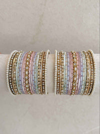 Set of multicolored pastel beaded bracelets on a beige surface with 'SokoraJewels.com' branding.