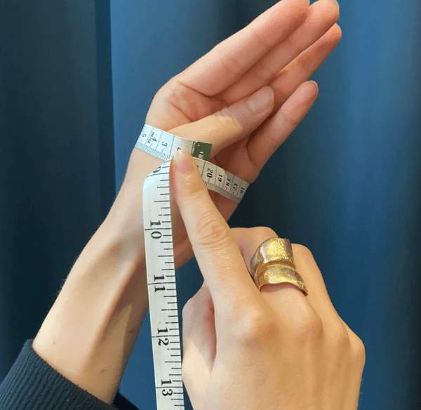 Measuring a bangle size with a tape